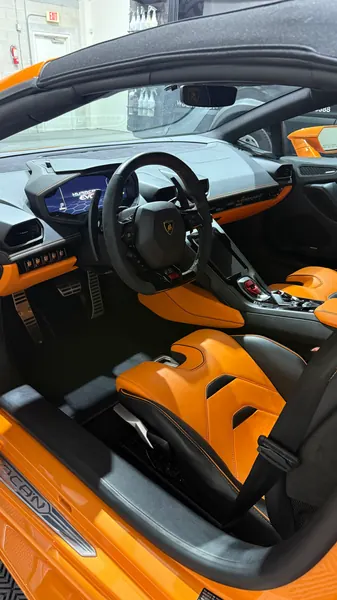 Clean orange and black Lamborghini Huracán interior, ceramic coating client in Sarasota