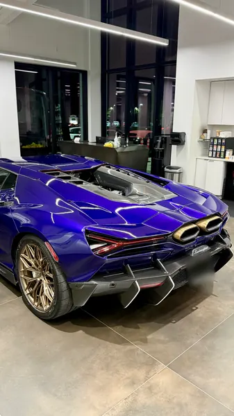 Rear three-quarter view of a purple Lamborghini Revuelto showing the exhausts and carbon diffuser, detail and polish for Lamborghini Sarasota